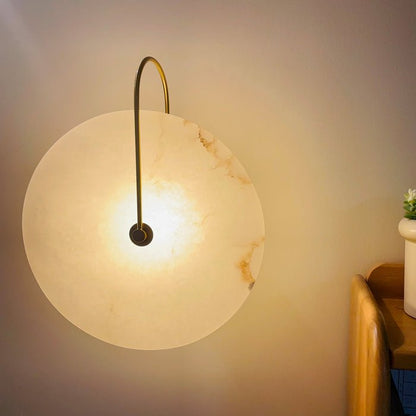 Alabaster wall lamp featuring integrated LED lighting and a unique snowflake pattern, designed with a modern minimalist aesthetic in black metal. 8