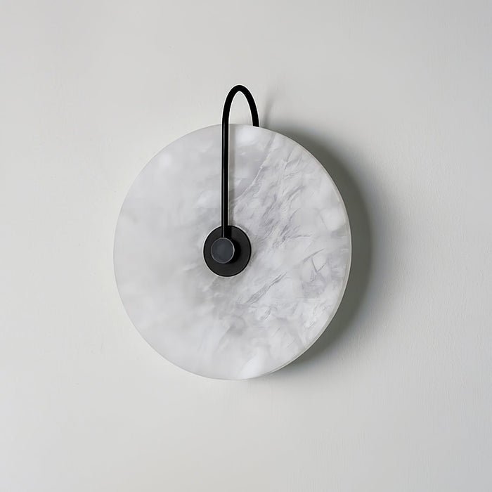 Alabaster wall lamp featuring integrated LED lighting and a unique snowflake pattern, designed with a modern minimalist aesthetic in black metal. 6