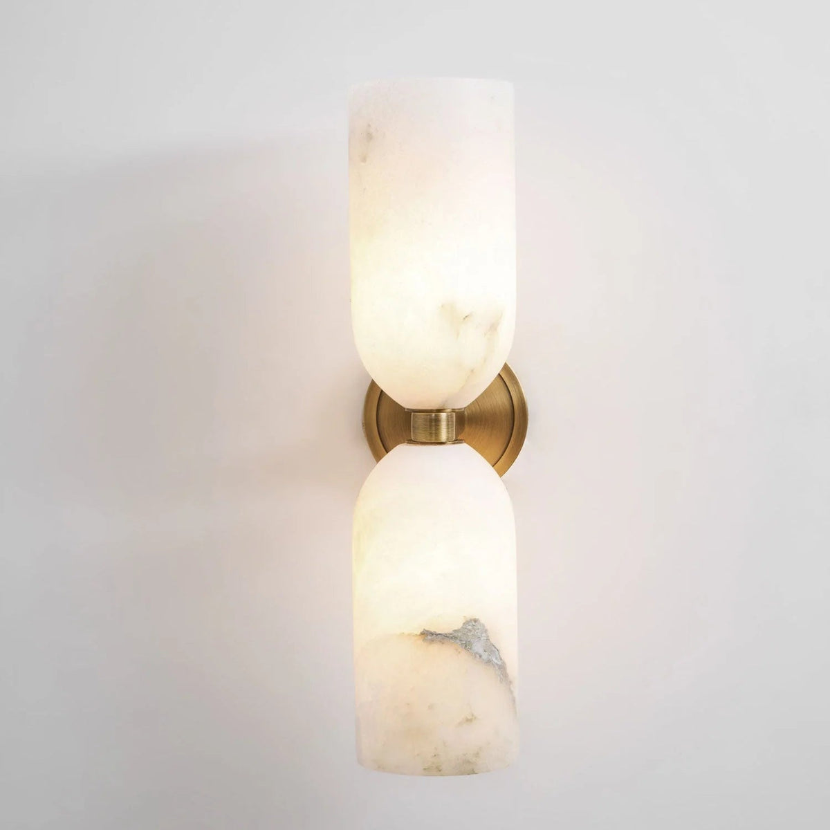 Alabaster wall light featuring an elegant up and down glow design, available in copper, black, or bronze finishes, perfect for modern home decor. 0