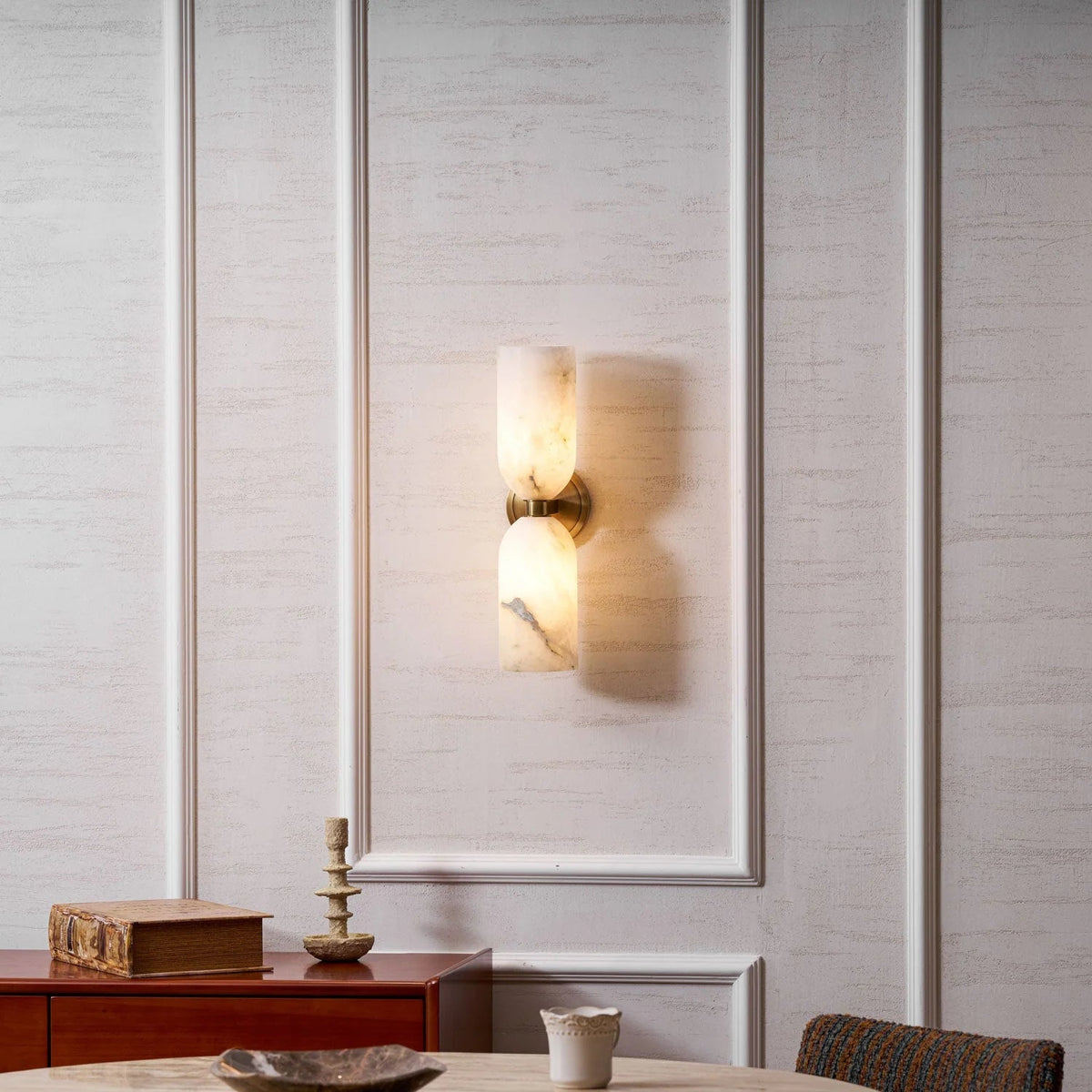 Alabaster wall light featuring an elegant up and down glow design, available in copper, black, or bronze finishes, perfect for modern home decor. 6