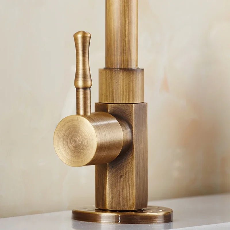 Antique brass kitchen faucet with swan neck spout and ceramic valve, showcasing an elegant design perfect for modern kitchens. 4
