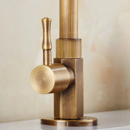 Antique brass kitchen faucet with swan neck spout and ceramic valve, showcasing an elegant design perfect for modern kitchens. 4