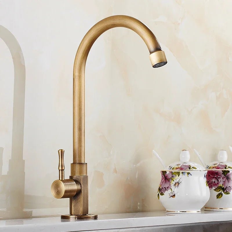 Antique brass kitchen faucet with swan neck spout and ceramic valve, showcasing an elegant design perfect for modern kitchens. 0