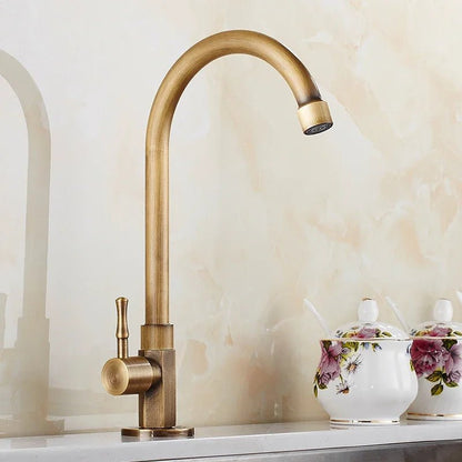 Antique brass kitchen faucet with swan neck spout and ceramic valve, showcasing an elegant design perfect for modern kitchens. 0