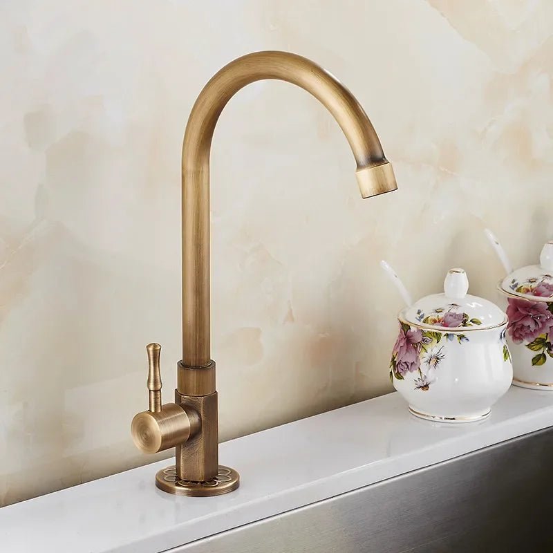 Antique brass kitchen faucet with swan neck spout and ceramic valve, showcasing an elegant design perfect for modern kitchens. 1