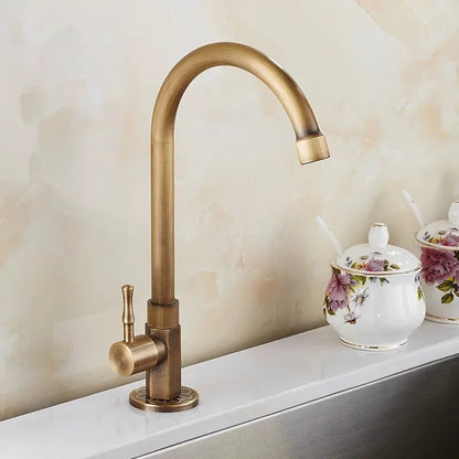 Antique brass kitchen faucet with swan neck spout and ceramic valve, showcasing an elegant design perfect for modern kitchens. 1