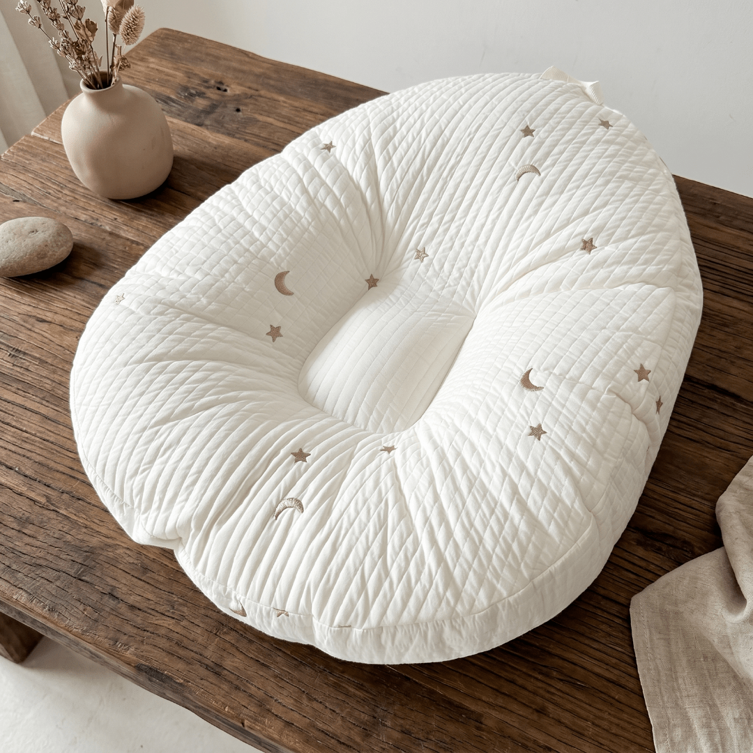 Baby lounger featuring ergonomic support, made with breathable cotton fabric, designed in a soft nest shape for optimal comfort and safety for infants. 8