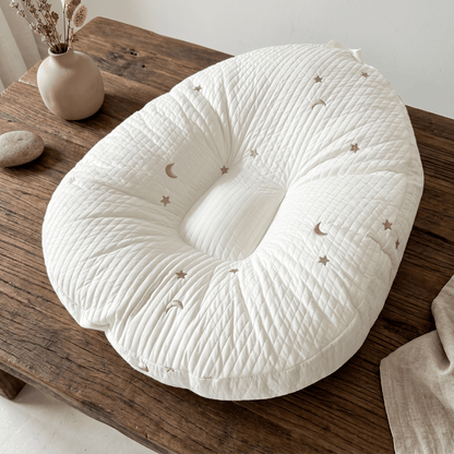 Baby lounger featuring ergonomic support, made with breathable cotton fabric, designed in a soft nest shape for optimal comfort and safety for infants. 8