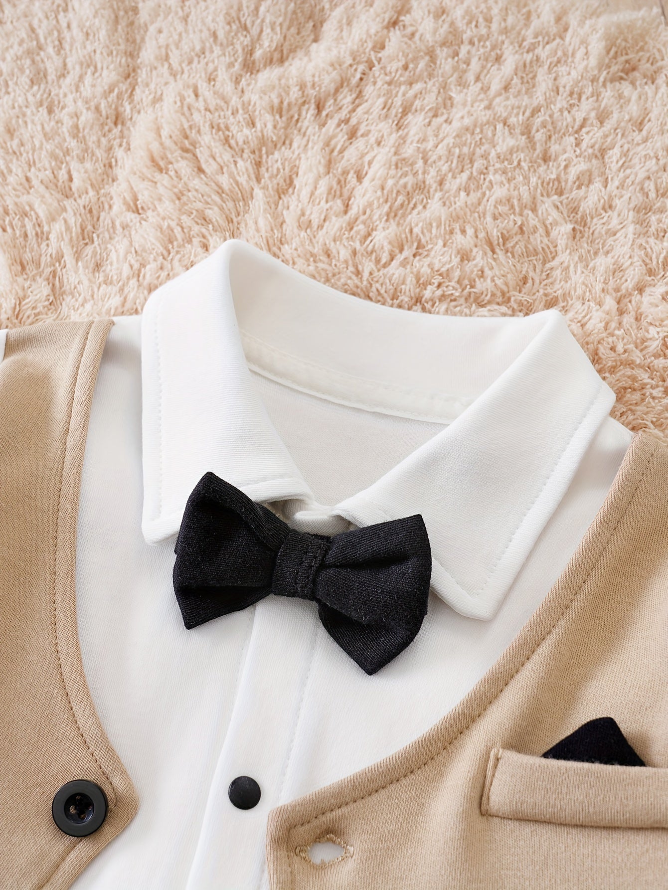 Baby romper featuring a stylish bow tie and cardigan design, made from soft cotton, perfect for special occasions and ensuring comfort for infants. 2