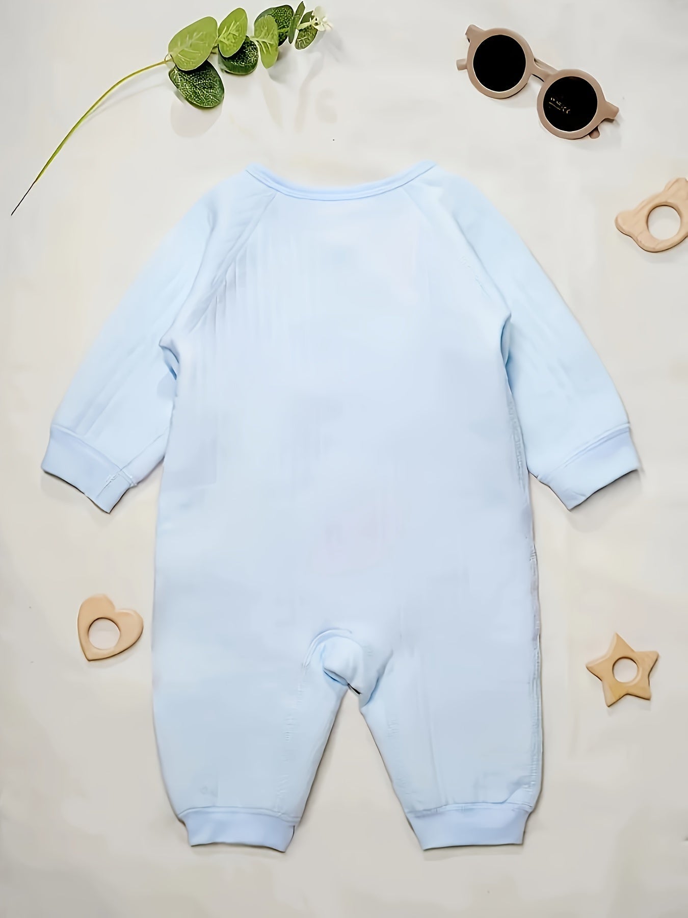 Baby romper featuring a playful bear patch, made from soft cotton for breathability during fall and winter, designed for easy dressing with bows and buttons. 5