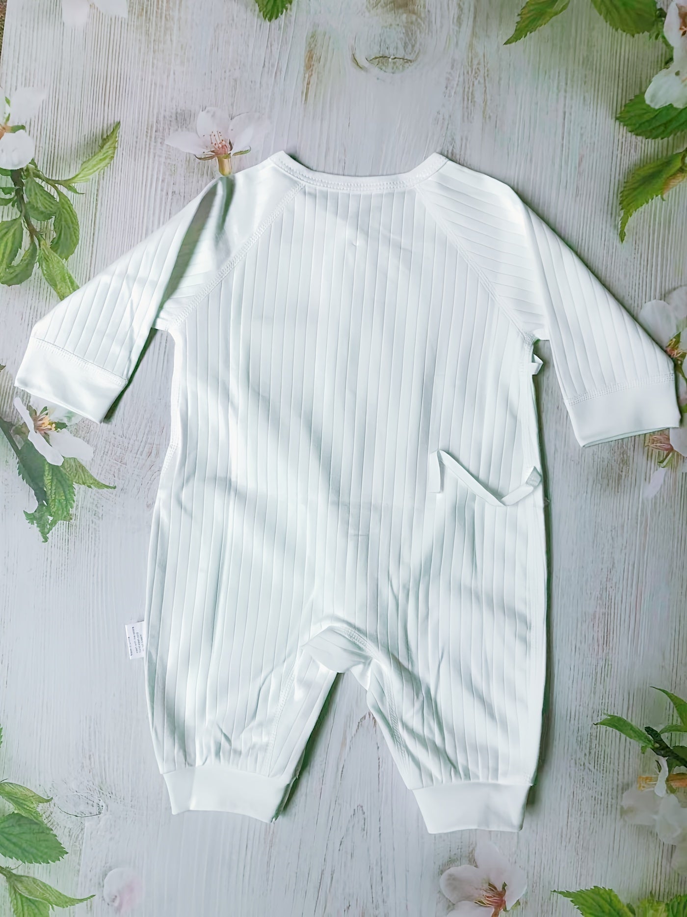 Baby romper featuring a playful bear patch, made from soft cotton for breathability during fall and winter, designed for easy dressing with bows and buttons. 6