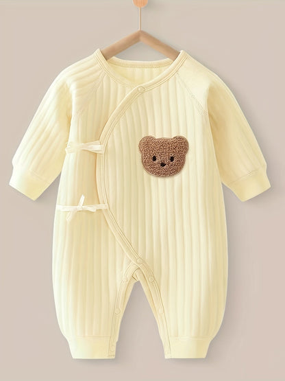 Baby romper featuring a playful bear patch, made from soft cotton for breathability during fall and winter, designed for easy dressing with bows and buttons. 2