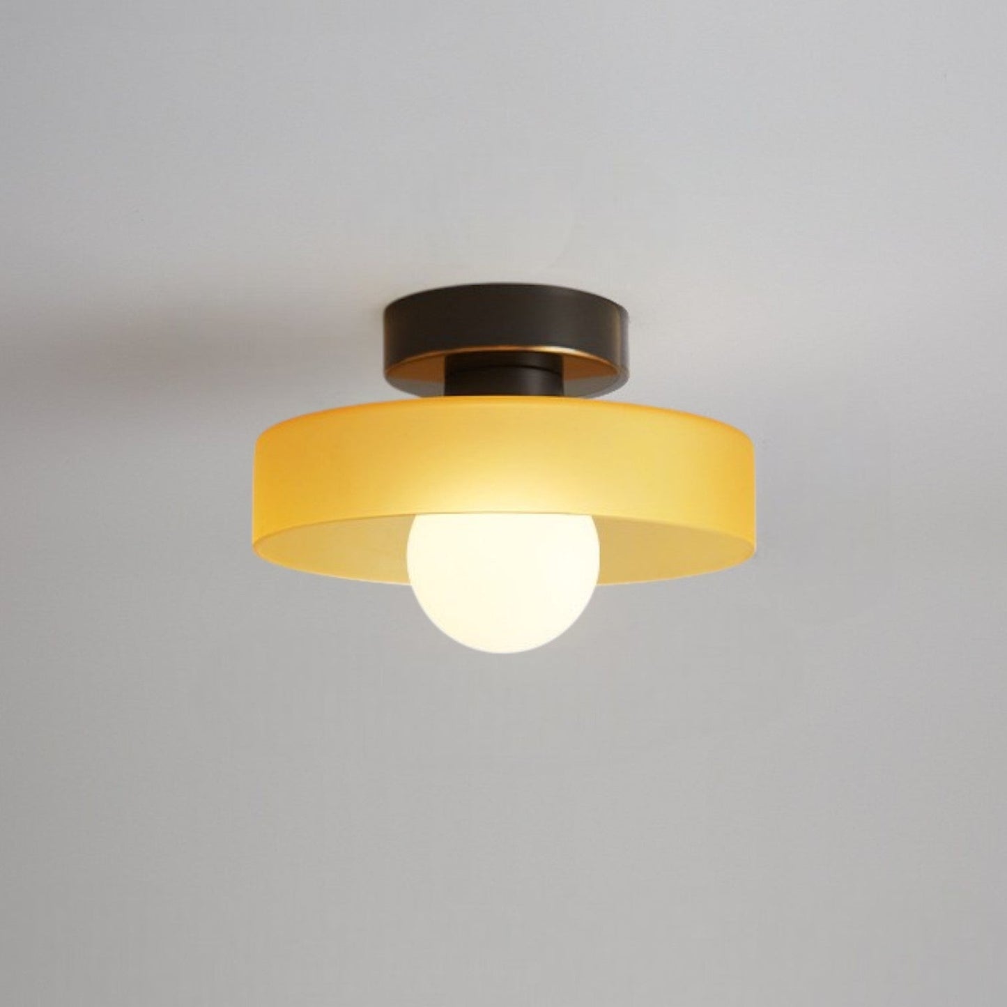 Bauhaus ceiling lamp featuring a minimalist design with a spherical glass shade and brass accents, perfect for modern bedroom decor. 7