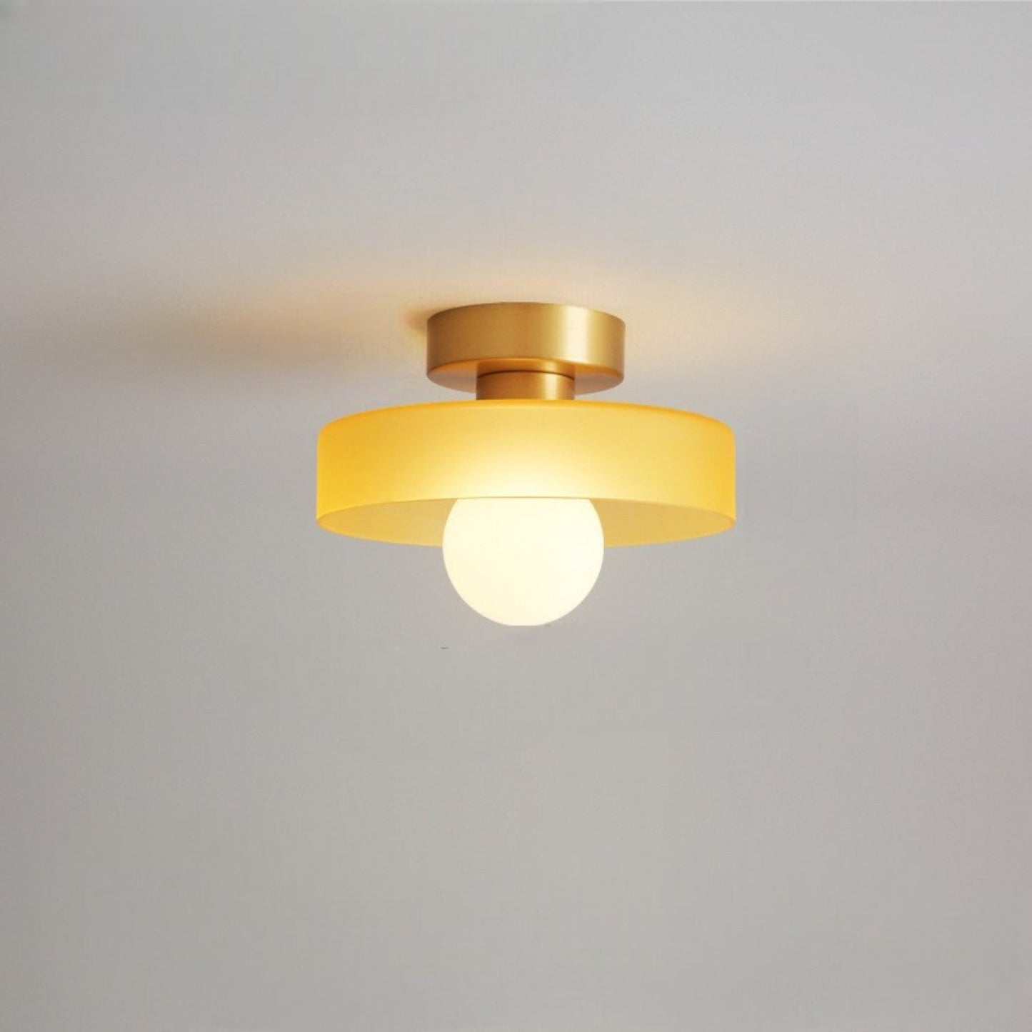 Bauhaus ceiling lamp featuring a minimalist design with a spherical glass shade and brass accents, perfect for modern bedroom decor. 8