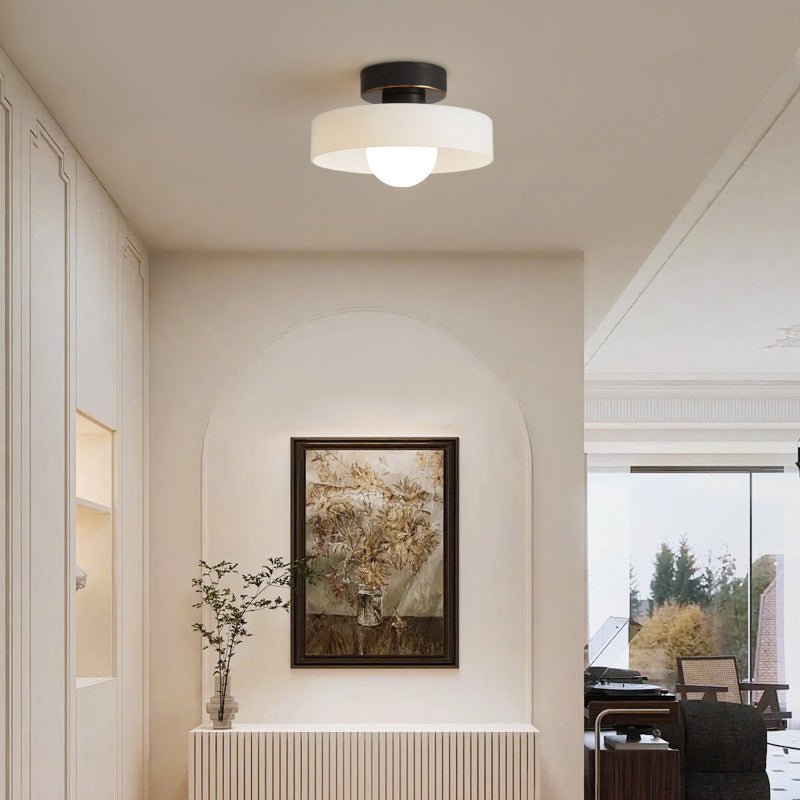 Bauhaus ceiling lamp featuring a minimalist design with a spherical glass shade and brass accents, perfect for modern bedroom decor. 1