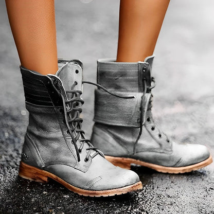 Black ankle boots for women featuring arch support and a non-slip sole, designed in a vintage distressed lace-up combat style. 1