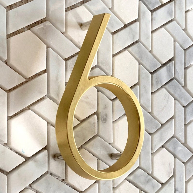 Elegant brass house numbers with a satin finish, designed for floating or flat installation, featuring a weather-resistant design for durability and style. 2