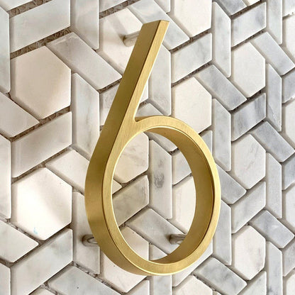 Elegant brass house numbers with a satin finish, designed for floating or flat installation, featuring a weather-resistant design for durability and style. 2