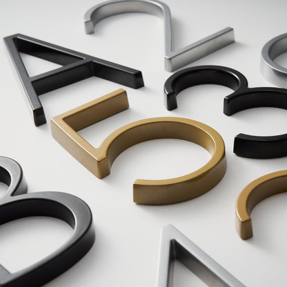 Elegant brass house numbers with a satin finish, designed for floating or flat installation, featuring a weather-resistant design for durability and style. 6