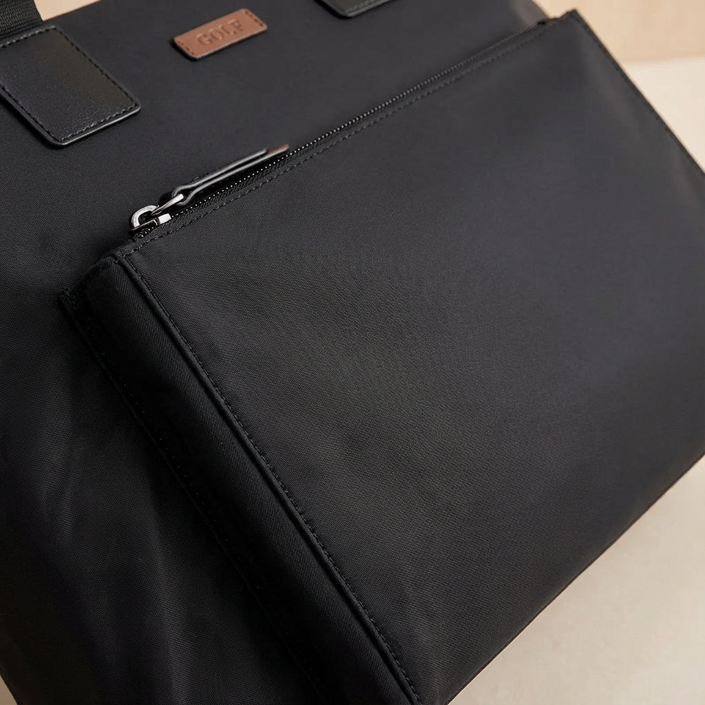 Gray and black canvas laptop bag featuring spacious compartments and an adjustable strap, designed for business commuters and men on the go. 3