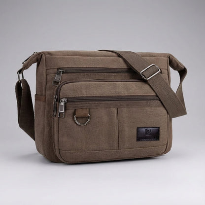 Canvas messenger bag featuring RFID blocking technology, multiple compartments for organization, and a durable waxed design for everyday use. 6