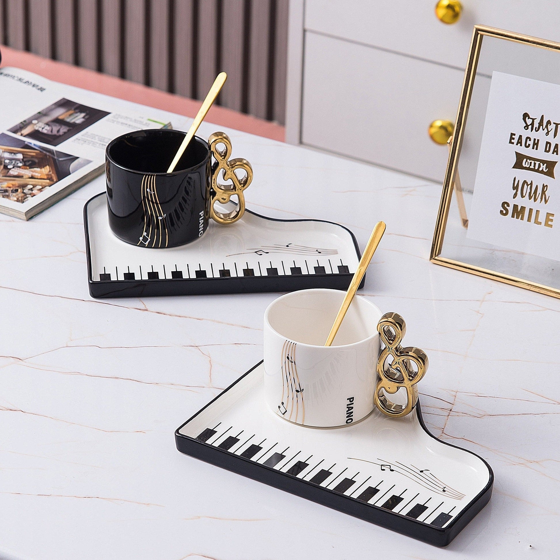 Ceramic cup and tray set featuring an elegant piano motif in white and black, complemented by a gold-plated spoon. 2