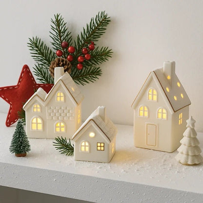 Ceramic Village Light with illuminated holiday houses, featuring intricate detailing and warm glowing lights, perfect for festive tabletop decoration. 0