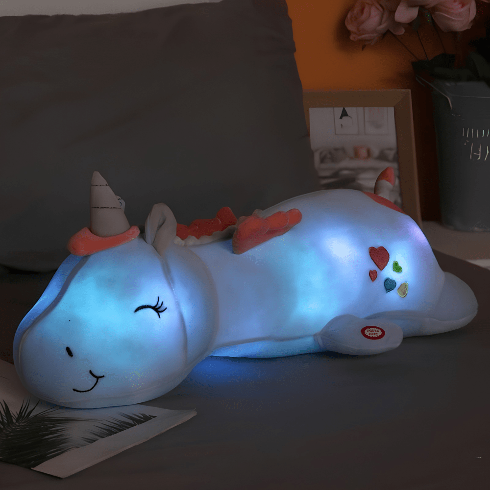 Children's plush night light featuring a soft unicorn design, providing a soothing LED glow for a comforting bedtime experience. 1
