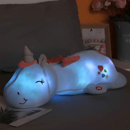 Children's plush night light featuring a soft unicorn design, providing a soothing LED glow for a comforting bedtime experience. 1