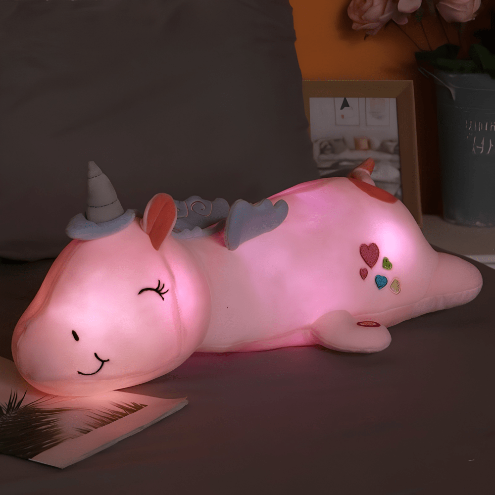 Children's plush night light featuring a soft unicorn design, providing a soothing LED glow for a comforting bedtime experience. 0