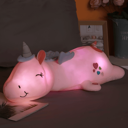 Children's plush night light featuring a soft unicorn design, providing a soothing LED glow for a comforting bedtime experience. 0