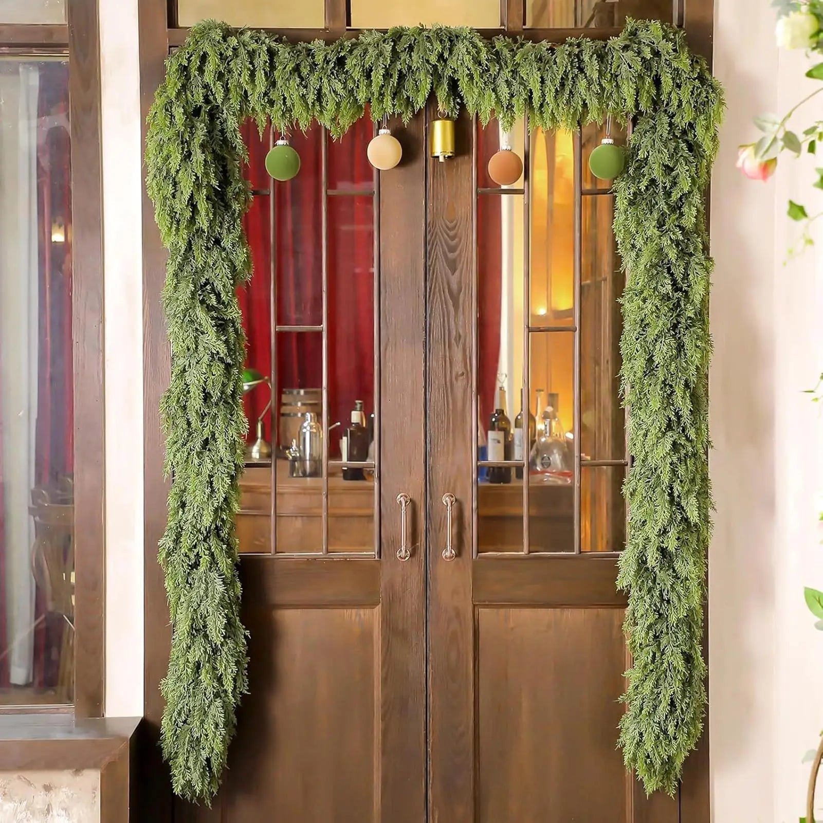 Christmas garland made of natural cypress branches, adorned with cotton accents, perfect for decorating fireplaces and windows during the winter season. 3