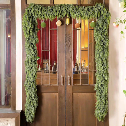 Christmas garland made of natural cypress branches, adorned with cotton accents, perfect for decorating fireplaces and windows during the winter season. 3