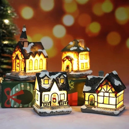 Christmas Village Decoration Set featuring snow-covered miniature houses illuminated by warm LED lights, perfect for tabletop display during the holiday season. 1