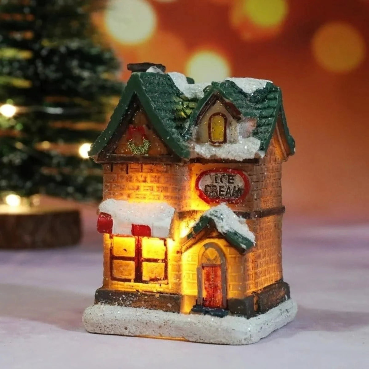 Christmas Village Decoration Set featuring snow-covered miniature houses illuminated by warm LED lights, perfect for tabletop display during the holiday season. 4
