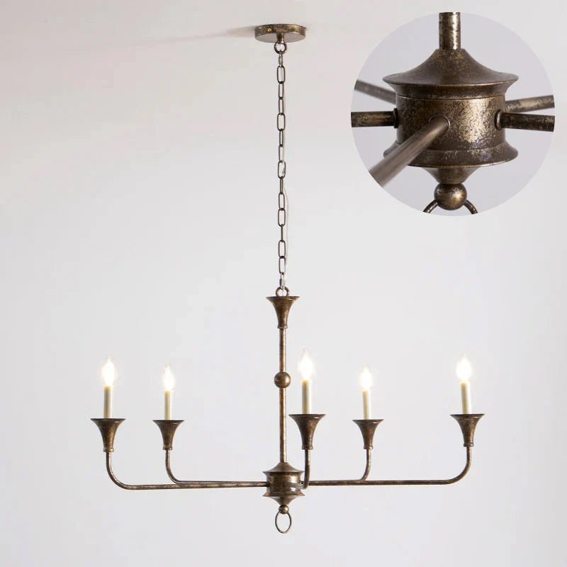 Classic chandelier light in antique brass with a candle-style design, featuring a flexible drop height, perfect for enhancing the elegance of dining rooms and entryways. 0