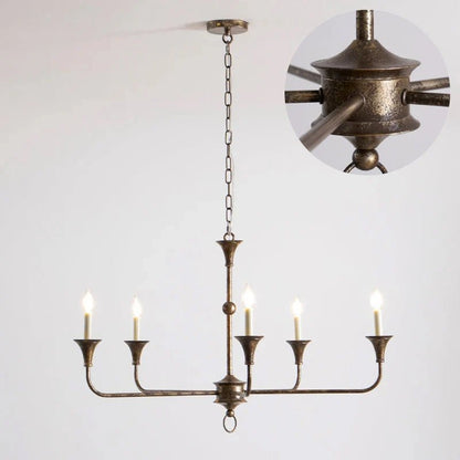 Classic chandelier light in antique brass with a candle-style design, featuring a flexible drop height, perfect for enhancing the elegance of dining rooms and entryways. 0