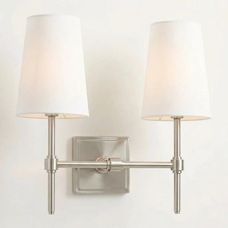 Classic wall light featuring a tapered linen shade and a dimmable function, available in elegant brass, sleek black, or modern brushed nickel finishes. 16
