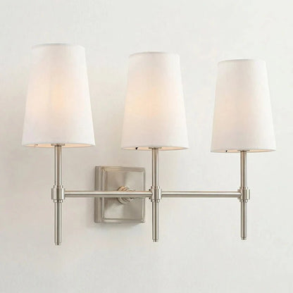 Classic wall light featuring a tapered linen shade and a dimmable function, available in elegant brass, sleek black, or modern brushed nickel finishes. 15