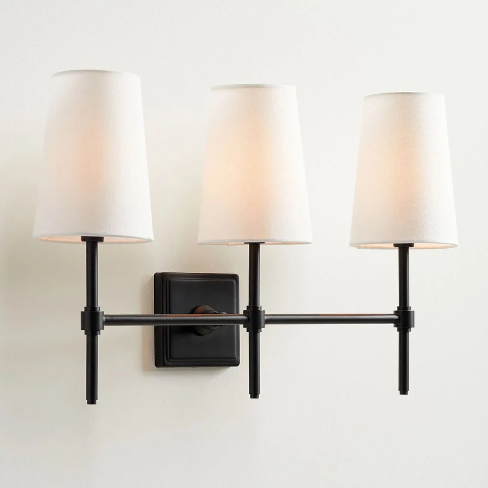 Classic wall light featuring a tapered linen shade and a dimmable function, available in elegant brass, sleek black, or modern brushed nickel finishes. 11