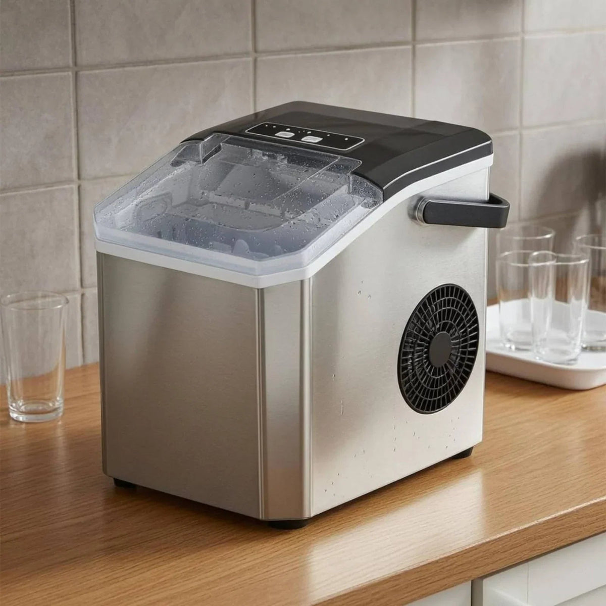 Compact Bullet Ice Maker with transparent lid, designed for home and office use, producing clear ice cubes efficiently on a sleek countertop. 3