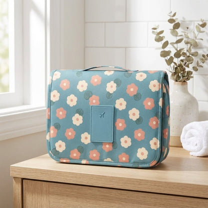 Compact hanging toiletry bag featuring a water-repellent surface and a vibrant floral print, designed as an organizer for women's travel essentials. 0