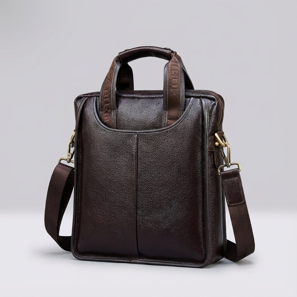 Compact brown leather shoulder bag made from genuine calf leather, featuring an adjustable strap for versatile wear. 1