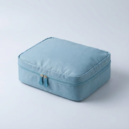 Compact makeup bag featuring waterproof fabric and multiple compartments for organized storage of cosmetics and beauty essentials. 6