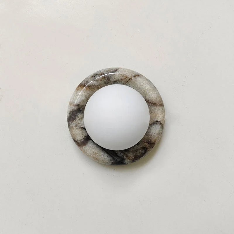 Compact Onyx Wall Light featuring a sleek design with a soft white glass diffuser, ideal for creating ambient lighting; dimmable hardwired fixture perfect for 9