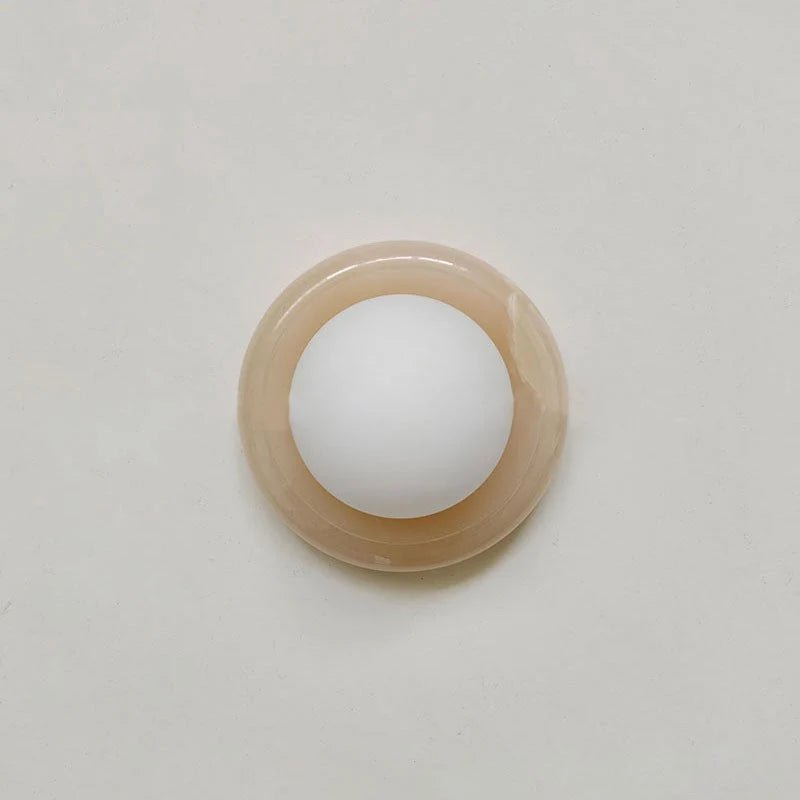 Compact Onyx Wall Light featuring a sleek design with a soft white glass diffuser, ideal for creating ambient lighting; dimmable hardwired fixture perfect for 11
