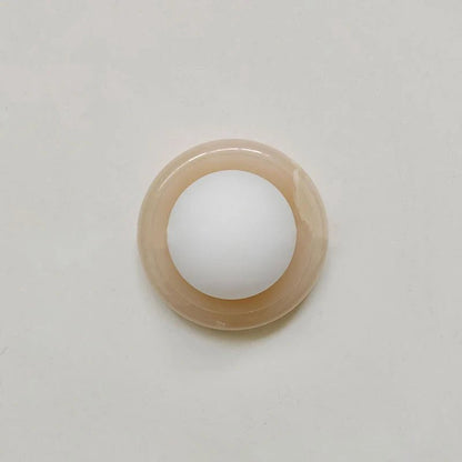 Compact Onyx Wall Light featuring a sleek design with a soft white glass diffuser, ideal for creating ambient lighting; dimmable hardwired fixture perfect for 11