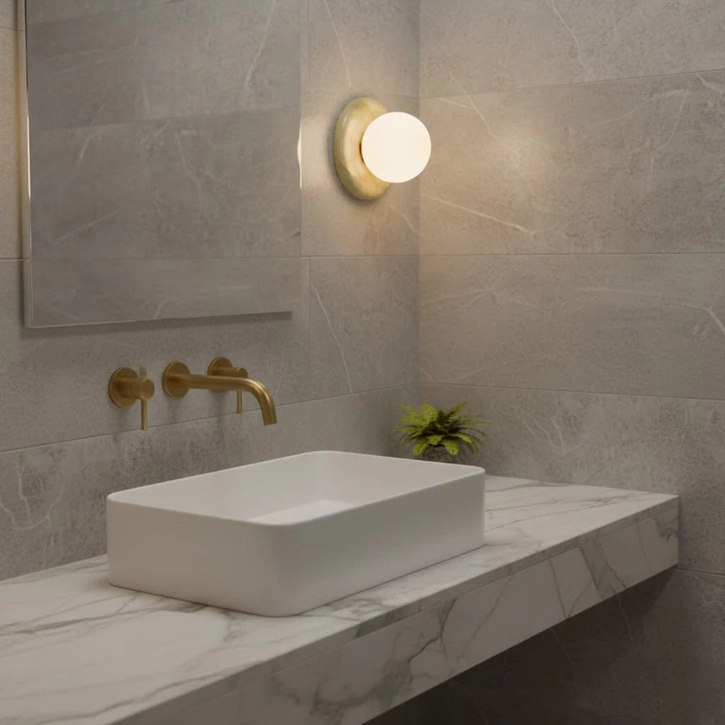 Compact Onyx Wall Light featuring a sleek design with a soft white glass diffuser, ideal for creating ambient lighting; dimmable hardwired fixture perfect for 7