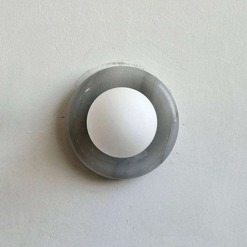 Compact Onyx Wall Light featuring a sleek design with a soft white glass diffuser, ideal for creating ambient lighting; dimmable hardwired fixture perfect for 16