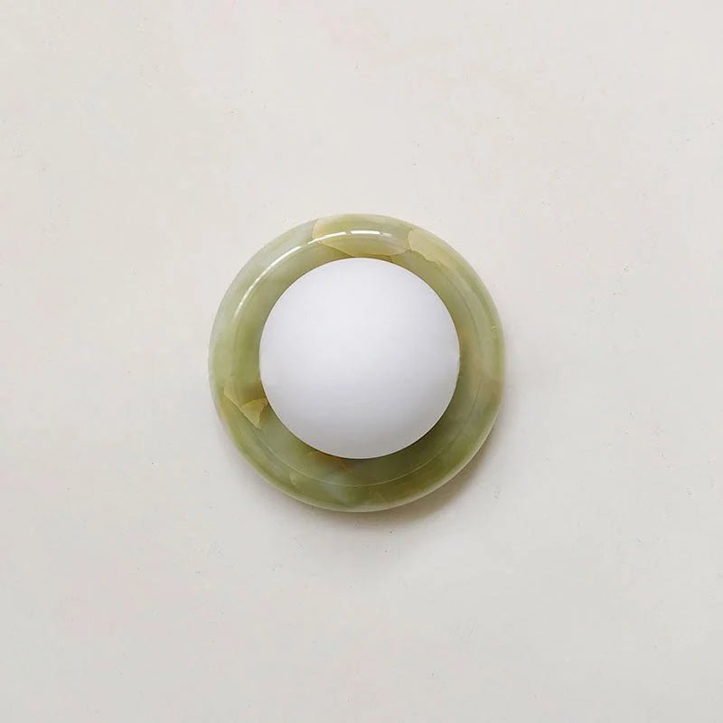 Compact Onyx Wall Light featuring a sleek design with a soft white glass diffuser, ideal for creating ambient lighting; dimmable hardwired fixture perfect for 12